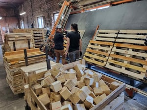 Employees working on custom wooden pallet production at Deligna’s manufacturing facility in Lithuania