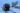 Sinikeltainen kuorma-auto autovaa'alla lumisessa ympäristössä